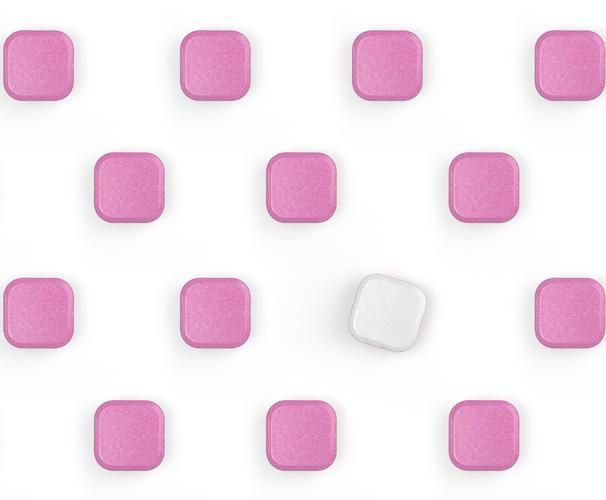 Lots of pink dishwasher tablets with a white one.