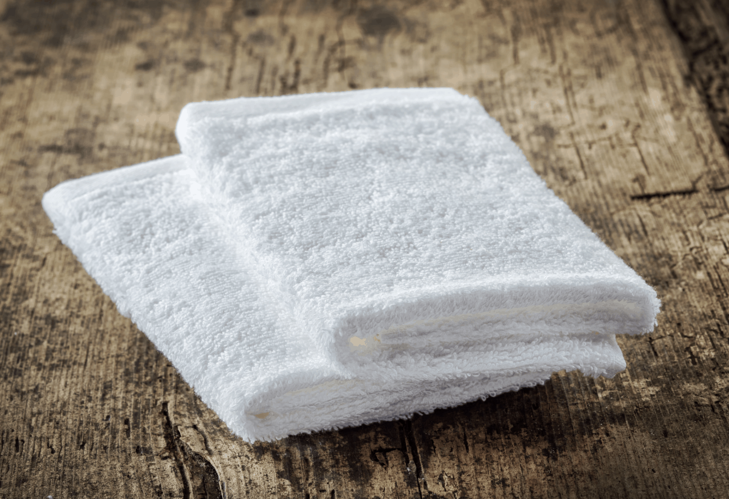 a pair of white washcloths as sustainable alternatives to plastic sponges